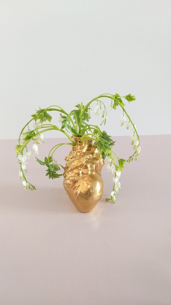 Floral composition with dicentra in a golden vase