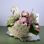 Floral compositioin in a Swan with white lilac