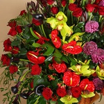 Funeral basket of red roses and cymbidium