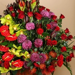 Funeral basket of red roses and cymbidium