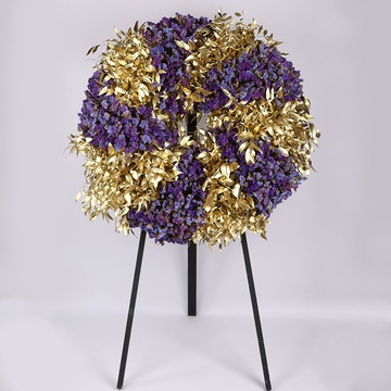 Funeral wreath made of statice and gold ruscus