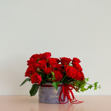 Composition of red rose in a box