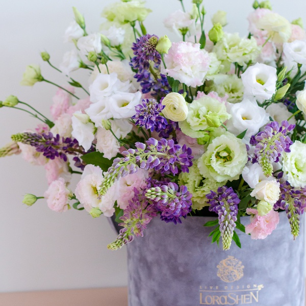 Floral composition with eustoma and lupine in a box