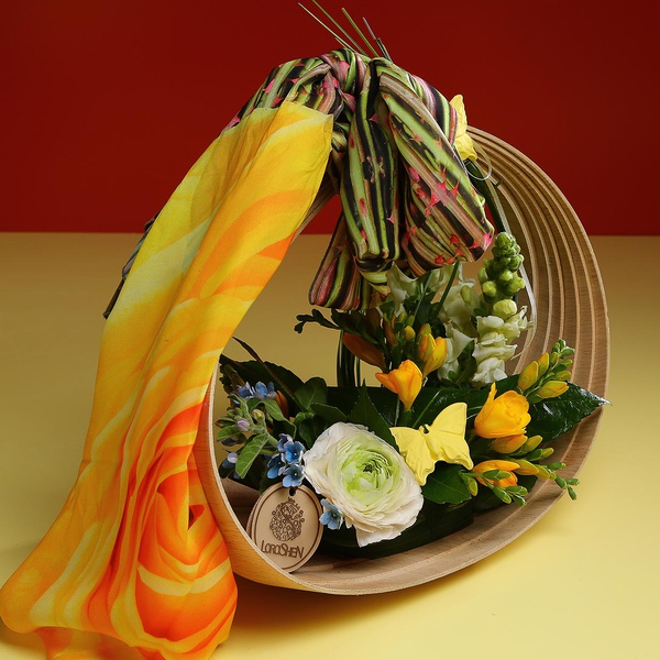 Composition in a basket with a yellow scarf