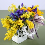 Floral composition in a hand bag yellow-violet