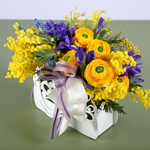 Floral composition in a hand bag yellow-violet