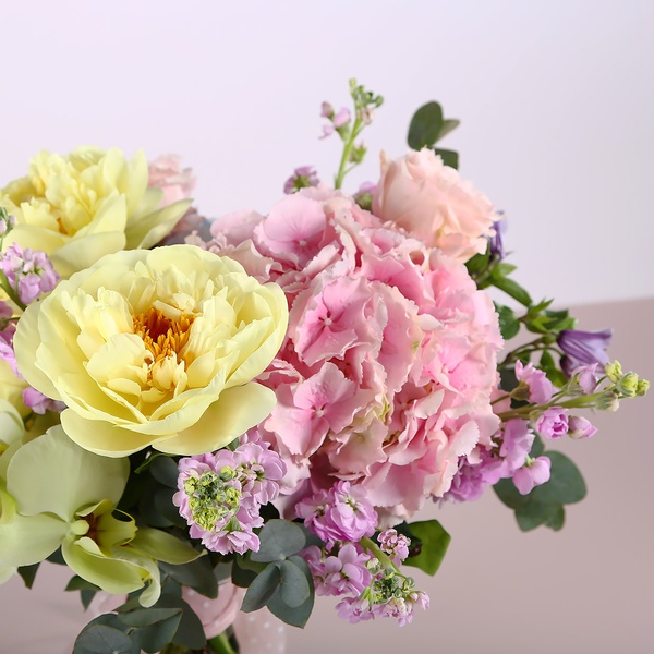 Bouquet with garden roses and yellow peonies
