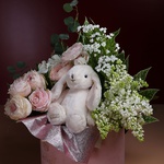 Flowers in a box with a soft toy bunny