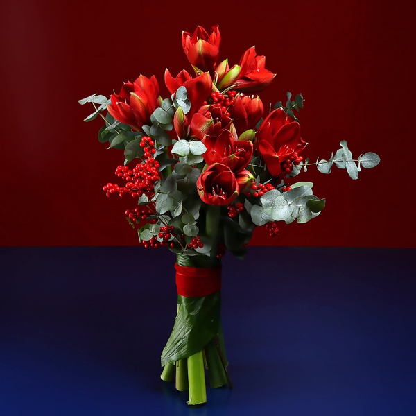 Bouquet of red amaryllis and ilex