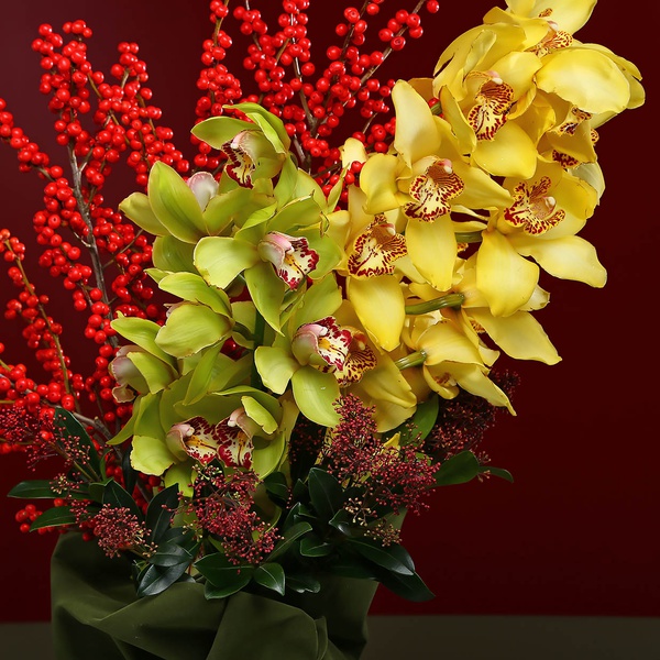 Bright bouquet with cymbidium and berries