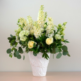 Bouquet with yellow peonies and delphinium in a vase