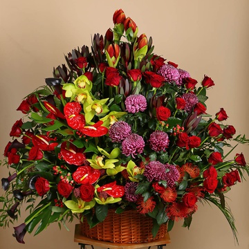 Funeral basket of red roses and cymbidium