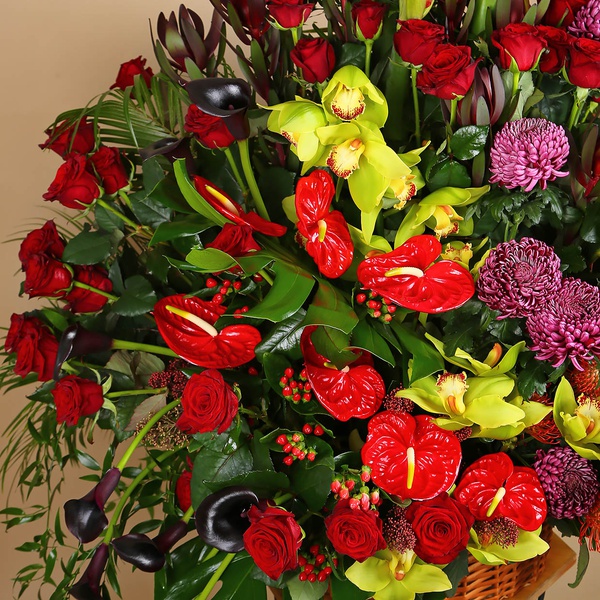 Funeral basket of red roses and cymbidium