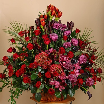 Funeral basket of red roses and amaryllis