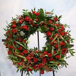 Mourning wreath in red tones with rose and hypericum