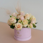 Composition in a box with roses and feathers