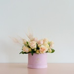 Composition in a box with roses and feathers