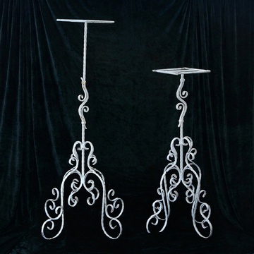 Elegant white metal racks with elegant openwork legs