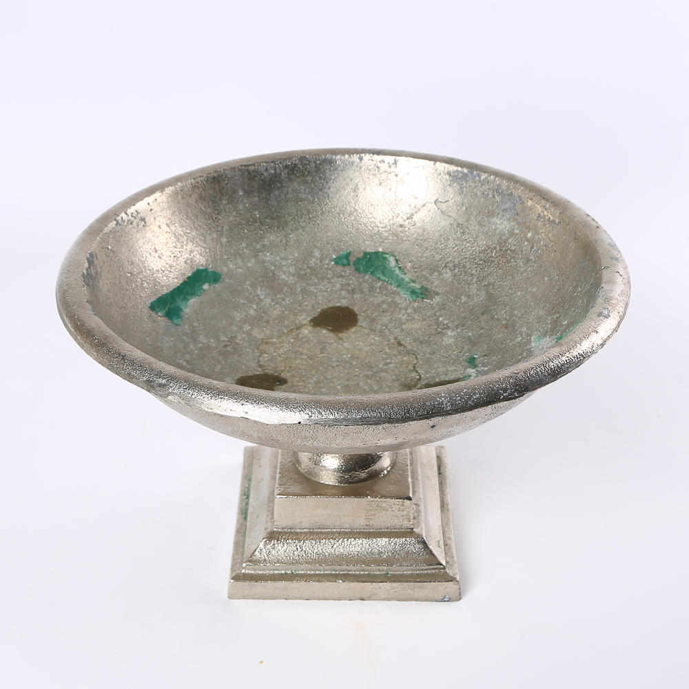 Tall decorative stand on a metal stem