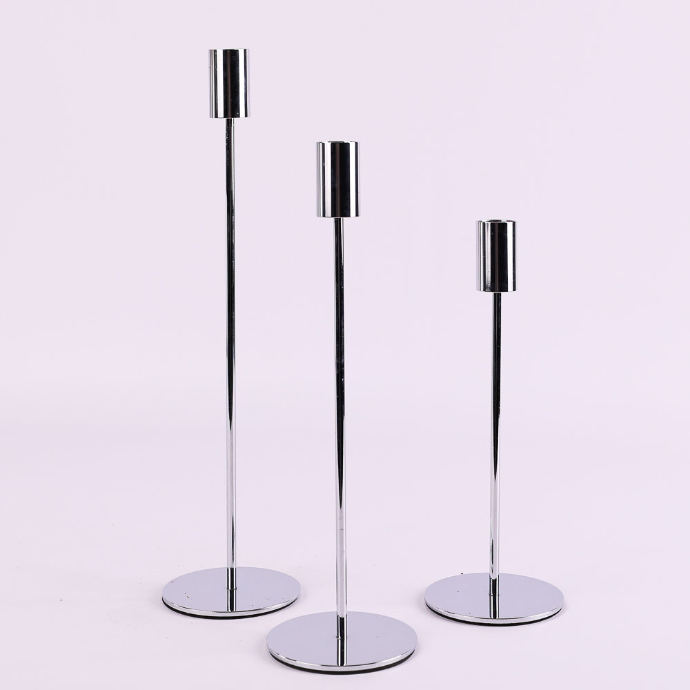 Stylish metal candle holders on tall stems