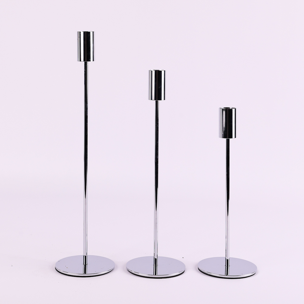Stylish metal candle holders on tall stems