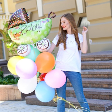 An armful of "Welcome baby" balloons