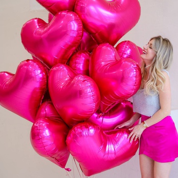 An armful of raspberry heart-shaped balloons, L