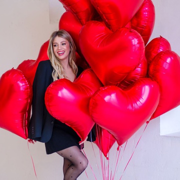 An armful of red heart balloons L