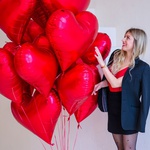 An armful of red heart balloons L