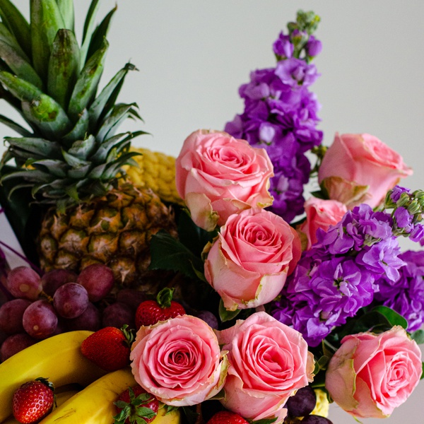 Wicker box with fruits and flowers
