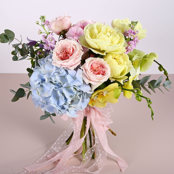 Bouquet with garden roses and yellow peonies