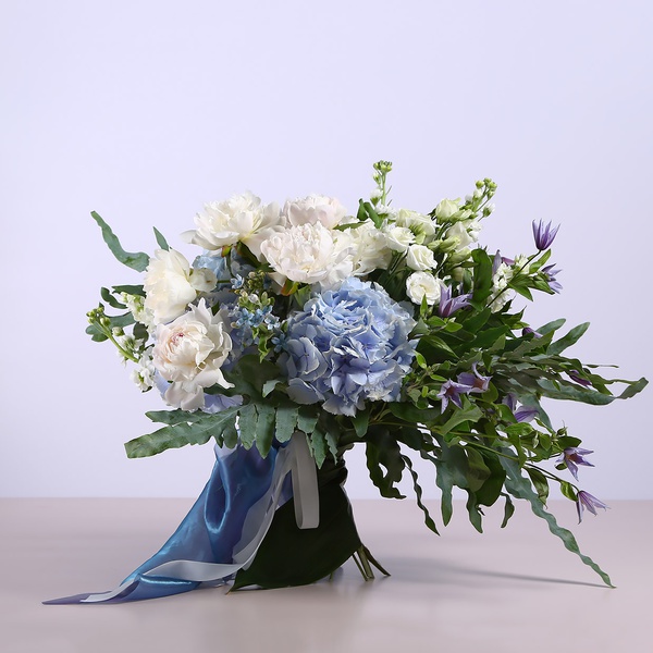 Summer bouquet with blue hydrangeas