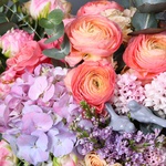 Floral composition with ranunculus and lilac