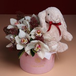 Flowers in a box with a soft toy