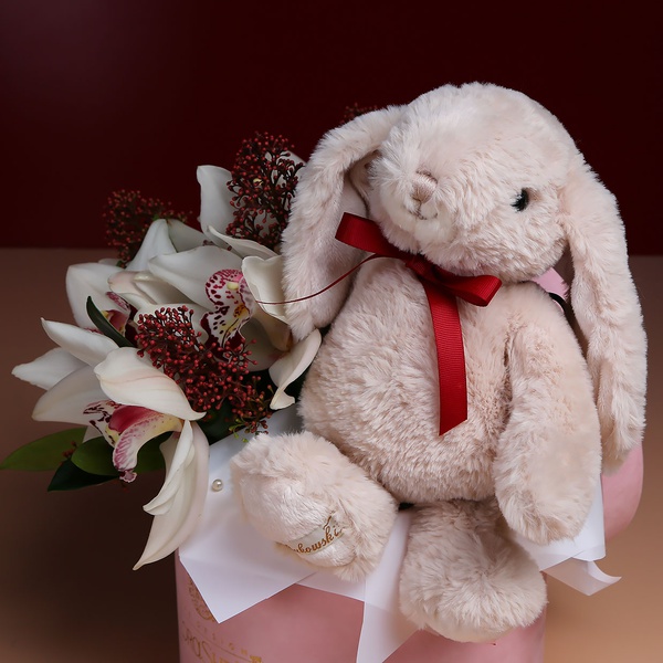 Flowers in a box with a soft toy