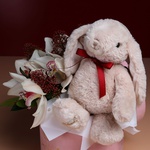 Flowers in a box with a soft toy