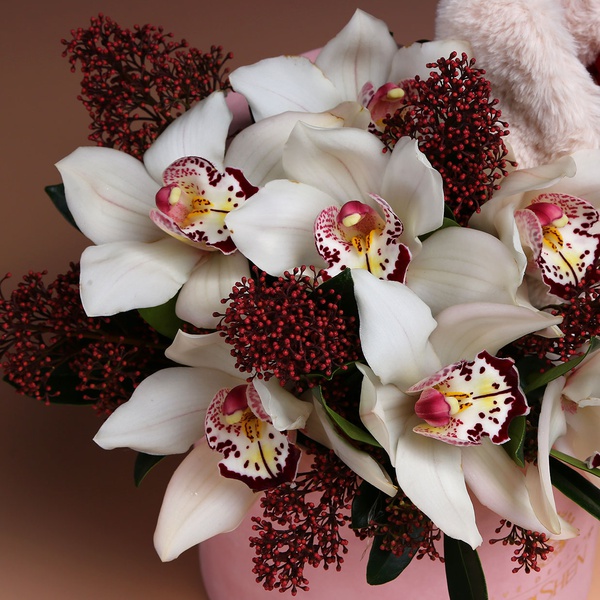 Flowers in a box with a soft toy