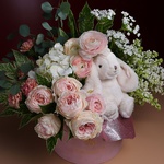 Flowers in a box with a soft toy bunny