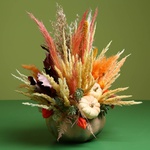 Flower in pumpkin with dried flowers
