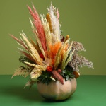 Flower in pumpkin with dried flowers