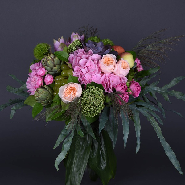 Flower bouquet with artichoke, apples and grapes