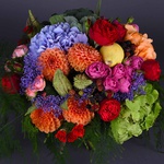 Autumn flower bouquet in bright contrasting shades with pumpkins