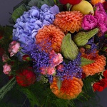 Autumn flower bouquet in bright contrasting shades with pumpkins