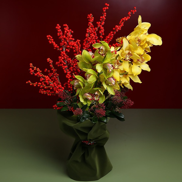 Bright bouquet with cymbidium and berries