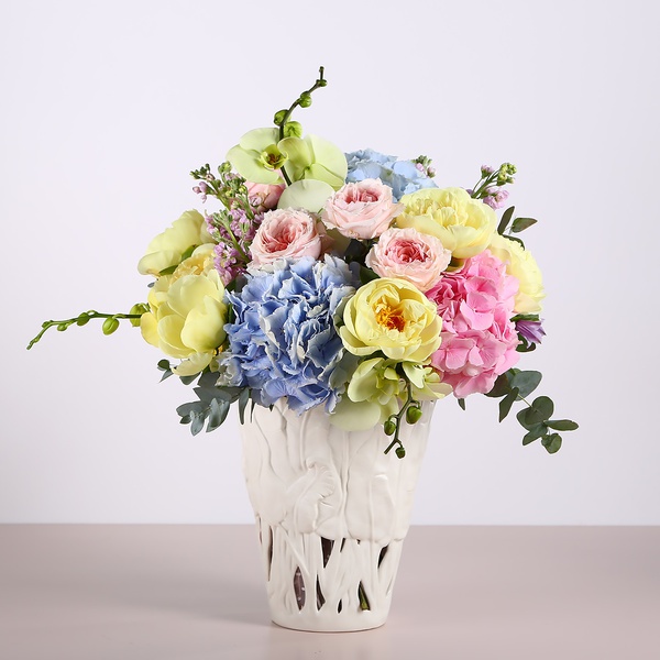 Bouquet with hydrangeas and yellow peonies in a vase