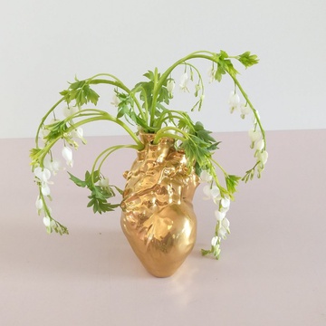 Floral composition with dicentra in a golden vase
