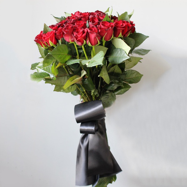Funeral bouquet of red roses with ribbon