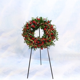 Mourning wreath in red tones with rose and hypericum
