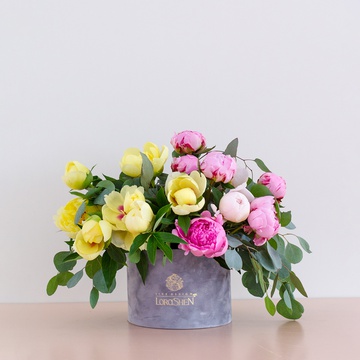Yellow and pink peonies in a box