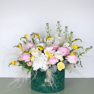 Composition with delicate ranunculus and sunny freesia